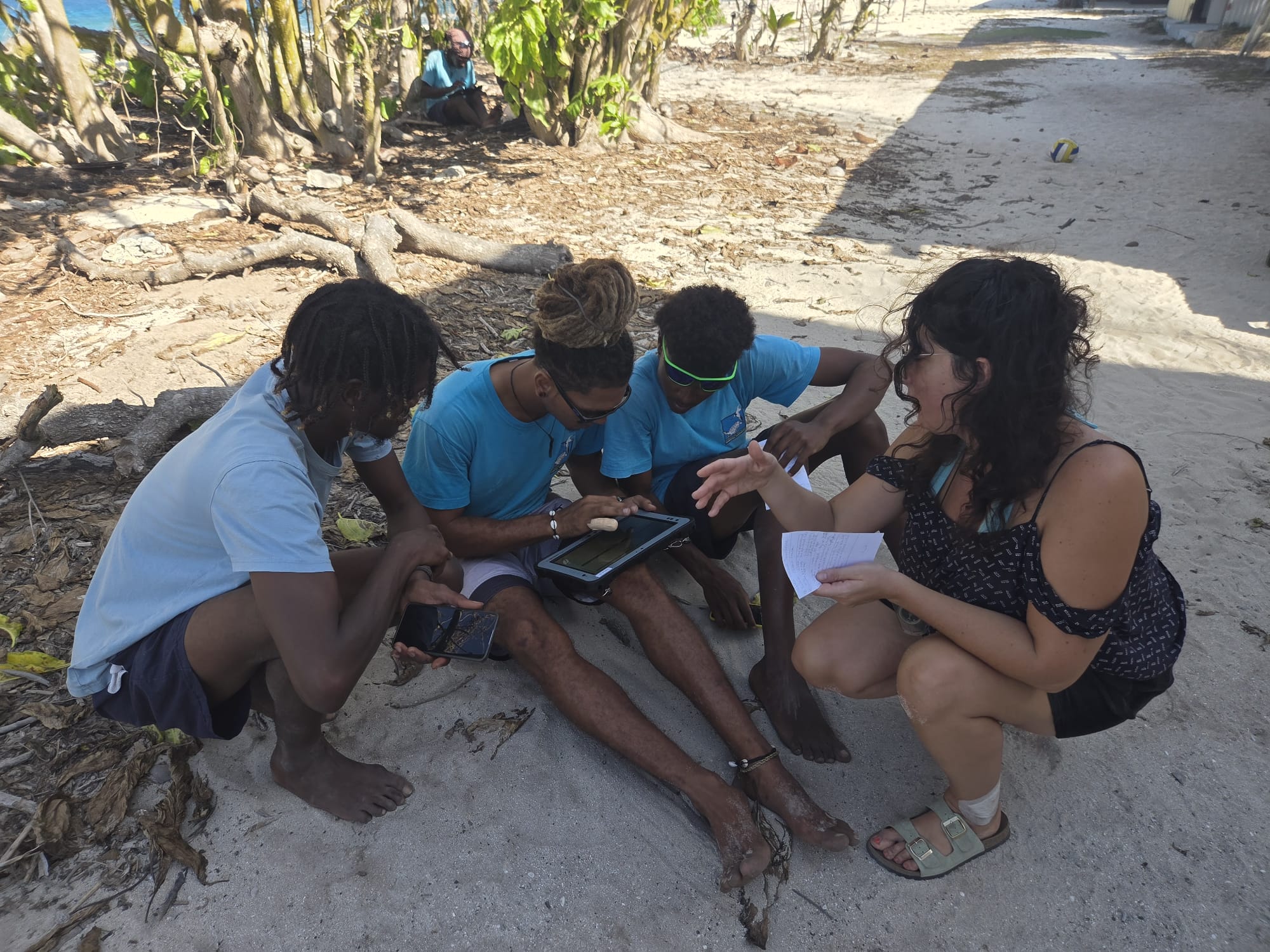 Field staff training with tablets on Cousin Island beach